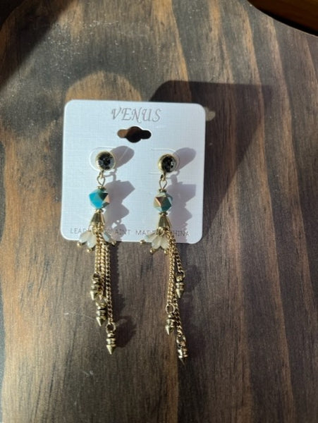 women's dangling gold earrings with blue jewel